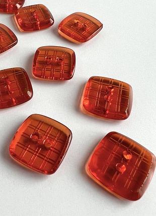 Пуговица  костюмная  в квадратики прозрачная 2отв красная 20мм пластик