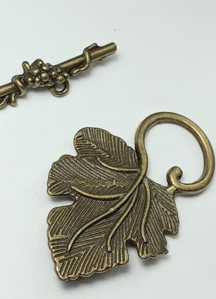 Замок тогл. розмір3,1×2,4 см. колір бронза