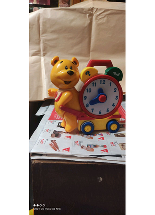 Навчальна іграшка з європи ведмедик з годинами їде1 фото