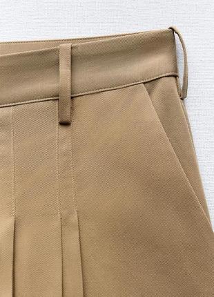 Мини-юбка с контрастной подкладкой на карманах5 фото