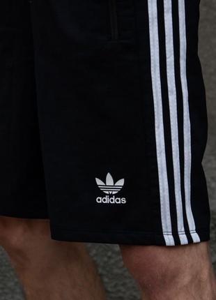 Шорти трикотажні adidas three line чорні.1 фото