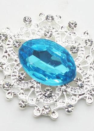 Камень в серебристой ажурной оправе  24*26 мм голубой