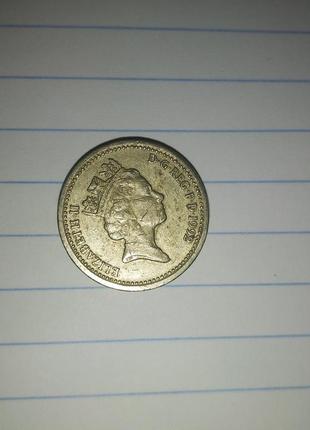 Монета 1 фунт1 фото