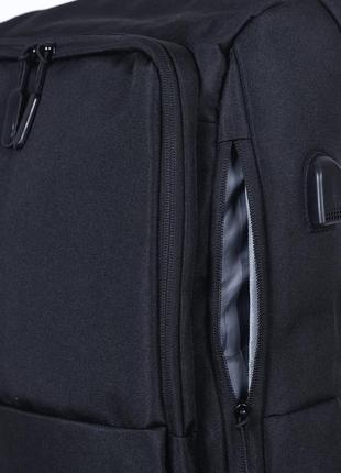 Чоловічий сучасний чорний міцний рюкзак з usb з кишенею під га...3 фото