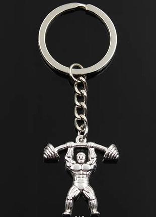 Брелок на ключи серебристый металл спорт штанга спортсмен поднимает штангу