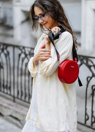 Жіноча шкіряна кругла сумка через плече крос-боді з натурально...7 фото