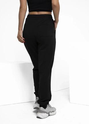 Чорні штани з декором на манжетах., розмір s3 фото
