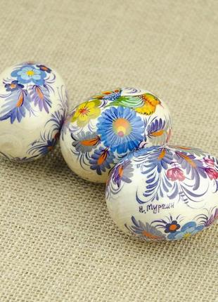Небольшое пасхальное декоративное деревянное яйцо, расписанное вручную петриковской росписью.2 фото