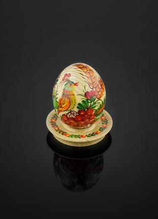 Невелике великоднє декоративне дерев'яне яйце, розписане вручну петриківським розписом.6 фото
