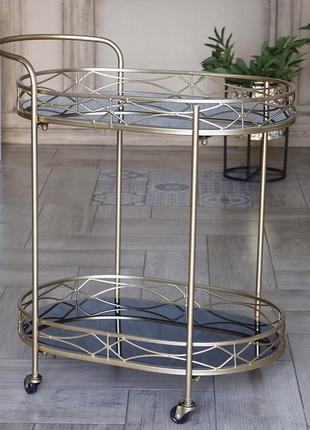 Сервірувальний золотий столик на колесах з металу з чорною скл...4 фото