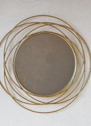 Настінне дзеркало кругле зі скла та металу із золотою рамою гр...1 фото