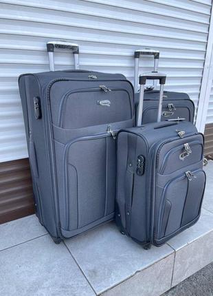 Набір тканинних валіз fly 8303-4 на 4 колесах 3 штуки сірий2 фото