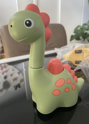 Іграшка динозаврик що їздить1 фото