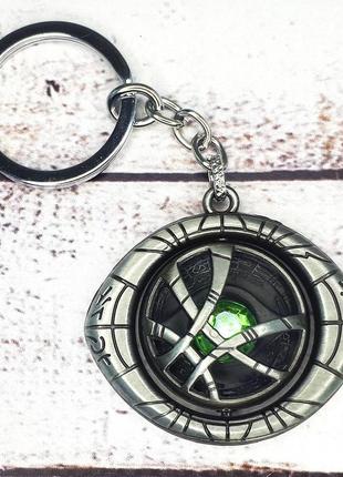 Брелок сгмдс 5022 доктор стрэндж глаз агамотто вращающийся (серебро)