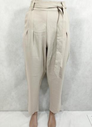 Бежеві штани на зав'язках з кишенями