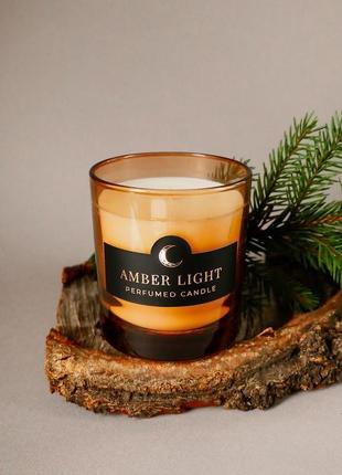 Парфумована свічка "amber light" у помаранчевій склянці