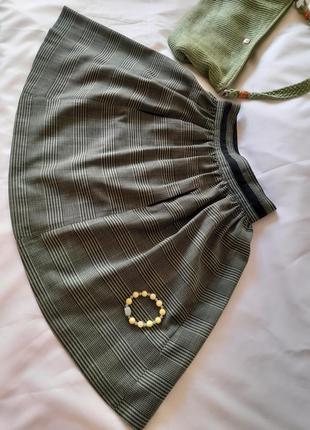 Клетчатая юбка черно - зеленого цвета1 фото