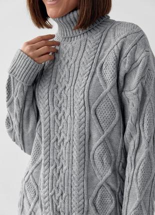 Удлиненный oversize свитер в косы
