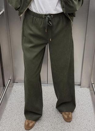 Фактурный брючный костюм в цвете хаки с кофтой на молнии и прямыми штанами