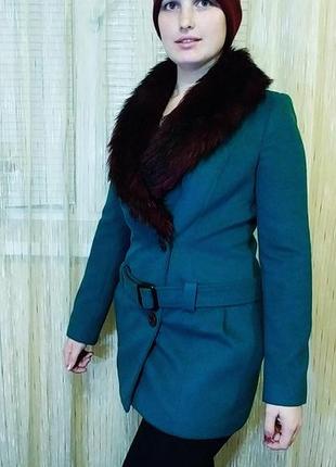 Зелене кашемірове пальто насичено зеленого кольору.