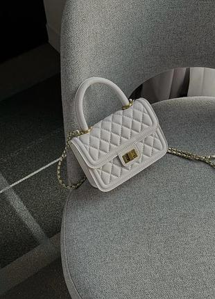 Маленька сумочка з еко-шкіри, з довгою ручкою та золотою фурнітурою