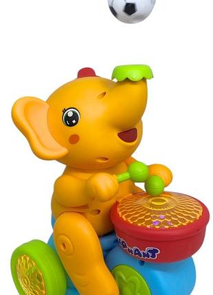 Слоник видуває м'ячик із барабаном рухомий жовтий музика світло звуки об'їзд перешкод слон жонглер