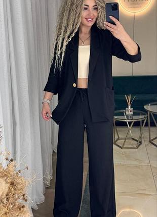 Льняной костюм с пиджаком на пуговице с накладными карманами со свободными брюками с карманами