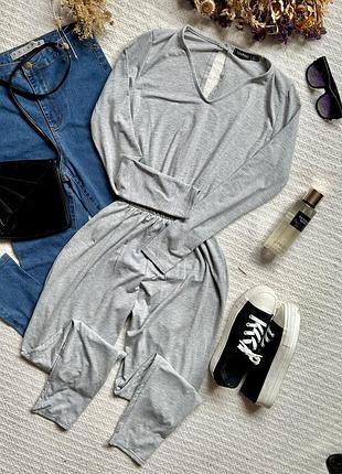 Базовий тонкий комбінезон з завуженими брюками та довгим рукавом сірого кольору