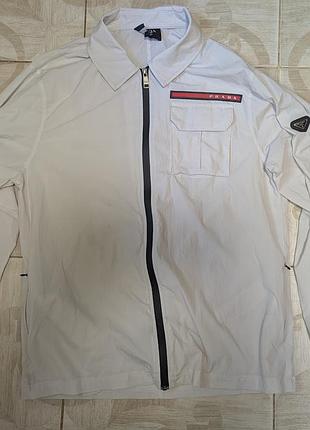 Сорочка-бомбер prada p.l
прямого кроя
рукава заканчиваются резинкой
ткань эластичная как ветровка