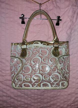 Прозрачная сумка с золотыми ручками. на молнии