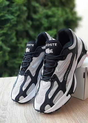 Мужские качественные тастильный кроссовки lacoste l003 2k24 св.серые с черным