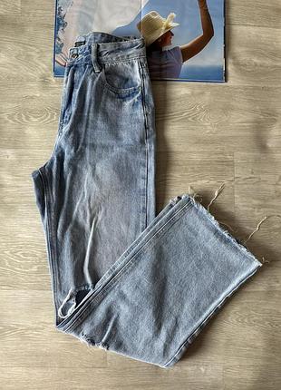 Широкие рваные голубые джинсы