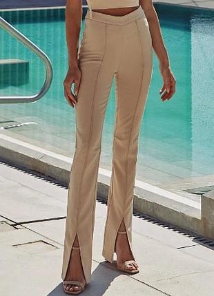 Бежеві жіночі брюки з розрізами