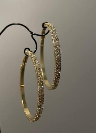 Великі сережки кільця в позолоті з камінцями