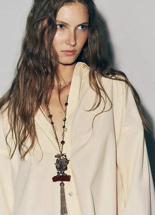 Ожерелье со звеньями, камнями и птицей