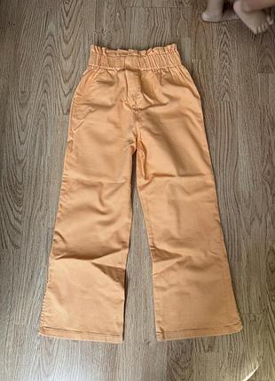 Джинси помаранчеві кльош з розрізами