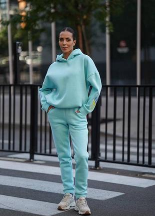 Теплий жіночий брючний костюм з вишивкою