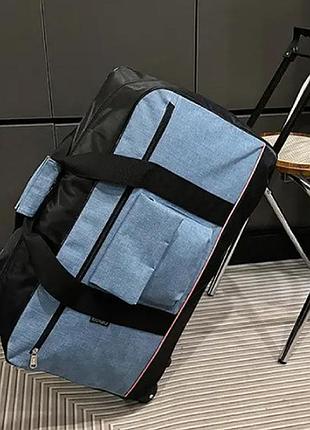 Большая плотная дорожная сумка с колесами вместительная с телескопической ручкой синяя 64 литра