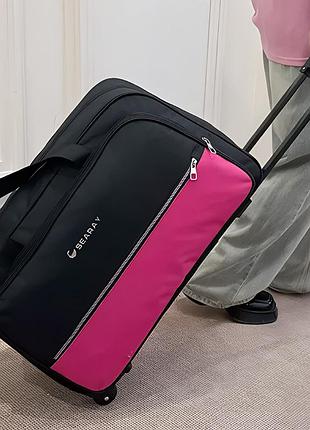 Женская дорожная сумка на колесах с телескопической ручкой 40 литров розовая