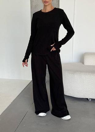 Жіночий повсякденний костюм штани палаццо лонгслів теплий на мікрофлісі чорного кольору