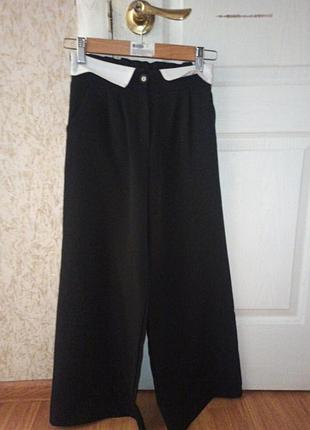 Брюки черного цвета с белыми вставками на рост 134-140 очень хороши в хорошем состоянии на пуговицы и сзади на резинке свободного кроя очень 
 привлекательные