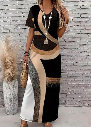 Елегантна жіноча сукня з v-подібним вирізом та коротким рукавом з геометричним принтом