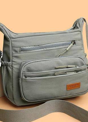 Текстильна жіноча сумочка,багато відділень,колір сірий.