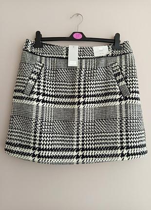 Тепла спідничка в клітинку з карманами