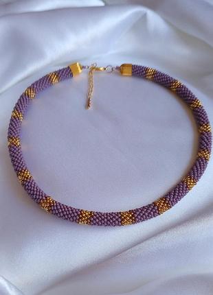 Жгут из темно сиреневого матового и золотого японского бисера.