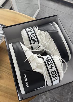 Білі дутики moonboot з чорними вставками