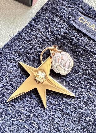 Chanel holiday 2025 star comet gold tone & small camellia flower charm.