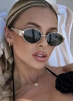 Очки солнцезащитные женские чёрныес золотой оправой металлической овальные ромб
