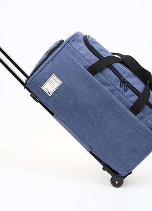 Плотная дорожная сумка с колесами вместительная с телескопической ручкой синяя 45 литров