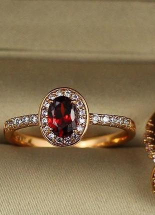 Кольцо xuping jewelry красный овальный фианит в кругу белых камней р 20 золотистое